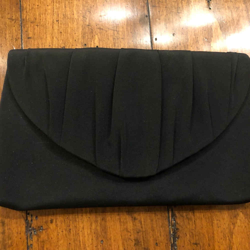 Black satin clutch with optional shoulder strap.